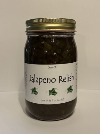 Jar of jalapeño relish with a metal screw-top lid on a white surface; label shows 'Jalapeno Relish' with small jalapeño illustrations and the word 'Sweet'.