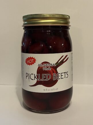 Glass jar of pickled beets with a gold twist-off lid and a white label reading 'PICKLED BEETS'